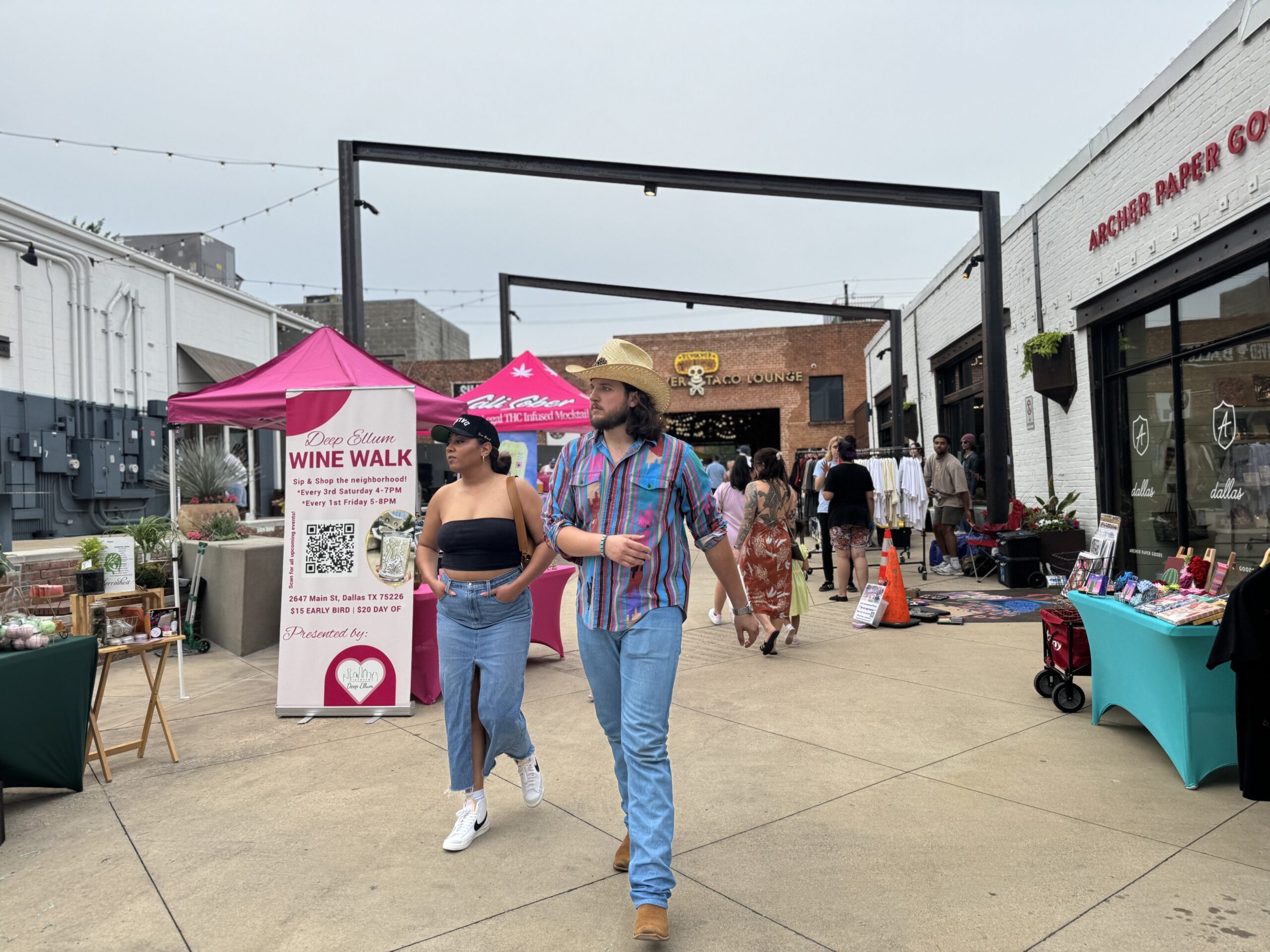 Visitors exploring a Deep Ellum outdoor market during the day